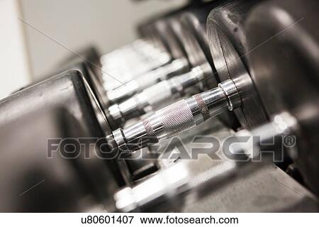 "Dumbbells in a row, close-up" View Large Photo Image Stock Photo - "Dumbbells in a row, close-up". Fotosearch