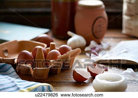 Stock Photograph - Eggs and salt on kitchen table. Fotosearch