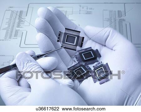 "Electronic components held in hand in laboratory, close up" View Large Photo Image Stock Image - "Electronic components held in hand in laboratory, close up". Fotosearch