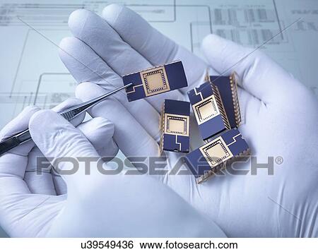 "Electronic components held in hand in laboratory, close up" View Large Photo Image Stock Photograph - "Electronic components held in hand in laboratory, close up". Fotosearch