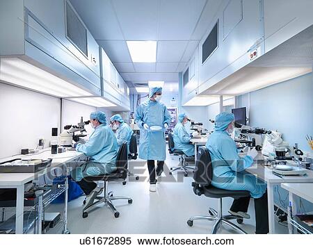 Electronics workers in clean room assembling electronic components View Large Photo Image Stock Photography - Electronics workers in clean room assembling electronic components. Fotosearch