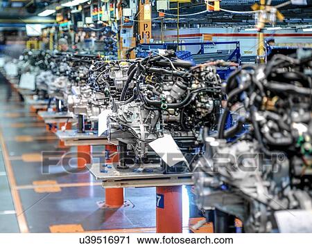 Stock Image - Engine production line in car factory. Fotosearch