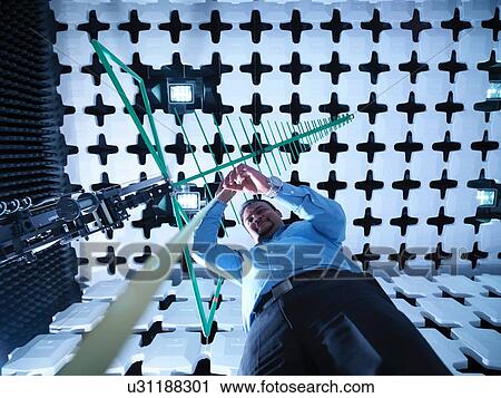 "Engineer checking a bilog antenna's height for electromagnetic compatibility (EMC) radiated immunity testing in a semi anechoic chamber, low angle view" View Large Photo Image Stock Image - "Engineer checking a bilog antenna's height for electromagnetic compatibility (EMC) radiated immunity testing in a semi anechoic chamber, low angle view". Fotosearch