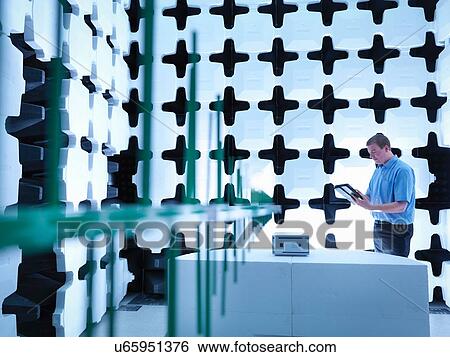 "Engineer checking the equipment under test (EUT), in a semi anechoic chamber with energy absorbers and bilog antenna set up for electromagnetic compatibility (EMC) radiated immunity testing" View Large Photo Image Stock Photograph - "Engineer checking the equipment under test (EUT), in a semi anechoic chamber with energy absorbers and bilog antenna set up for electromagnetic compatibility (EMC) radiated immunity testing". Fotosearch