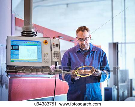 Engineer holding laser cut component in engineering factory View Large Photo Image Stock Image - Engineer holding laser cut component in engineering factory. Fotosearch