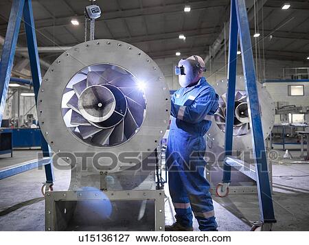 Engineer welding airduct part in engineering factory View Large Photo Image Stock Photo - Engineer welding airduct part in engineering factory. Fotosearch