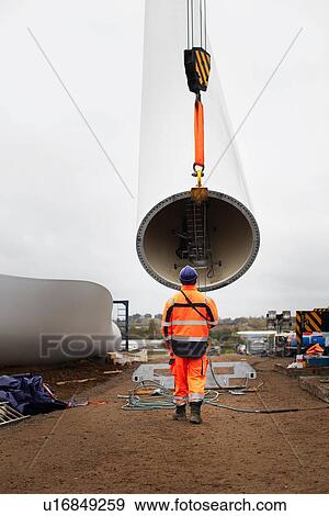Stock Photo - Engineer working at wind farm. Fotosearch