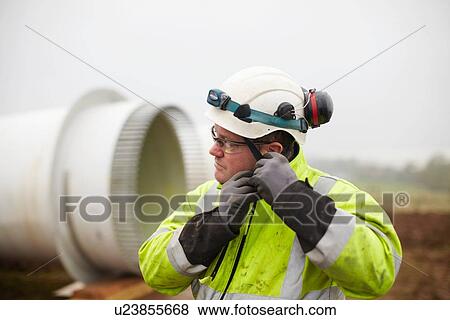 Engineer working at wind farm View Large Photo Image Stock Photo - Engineer working at wind farm. Fotosearch