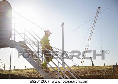 Engineer working at wind farm View Large Photo Image Stock Photo - Engineer working at wind farm. Fotosearch