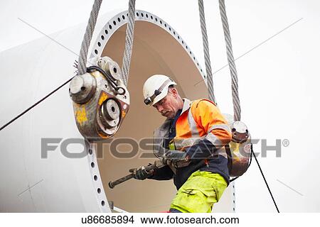 Engineer working on wind turbine View Large Photo Image Picture - Engineer working on wind turbine. Fotosearch
