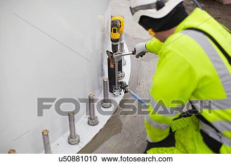 "Engineer working on wind turbine, rear view" View Large Photo Image Stock Image - "Engineer working on wind turbine, rear view". Fotosearch
