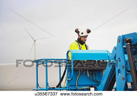 Engineer working on wind turbine View Large Photo Image Stock Photo - Engineer working on wind turbine. Fotosearch