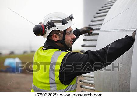 Stock Photo - Engineer working on wind turbine. Fotosearch