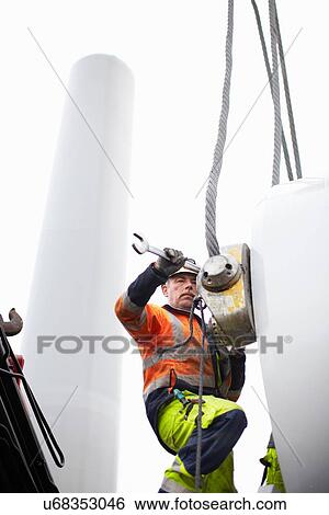 Stock Photograph - Engineer working on wind turbine. Fotosearch
