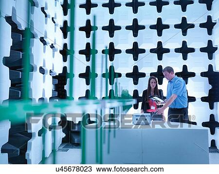 "Engineers checking the equipment under test (EUT), in a semi anechoic chamber with energy absorbers and bilog antenna set up for electromagnetic compatibility (EMC) radiated immunity testing" View Large Photo Image Stock Image - "Engineers checking the equipment under test (EUT), in a semi anechoic chamber with energy absorbers and bilog antenna set up for electromagnetic compatibility (EMC) radiated immunity testing". Fotosearch