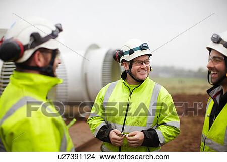 Picture - Engineers having conversation at wind farm. Fotosearch