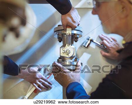 "Engineers maintaining pipework in power station, close up" View Large Photo Image Stock Image - "Engineers maintaining pipework in power station, close up". Fotosearch