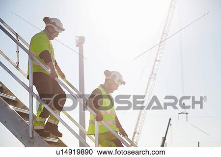 Stock Image - Engineers working at wind farm. Fotosearch
