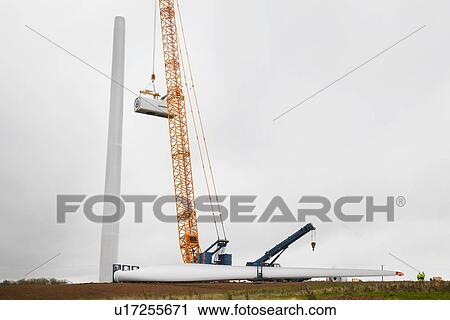 Stock Image - Engineers working at wind farm. Fotosearch