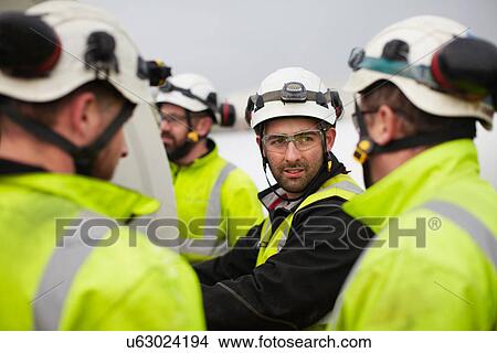Picture - Engineers working on wind turbine. Fotosearch