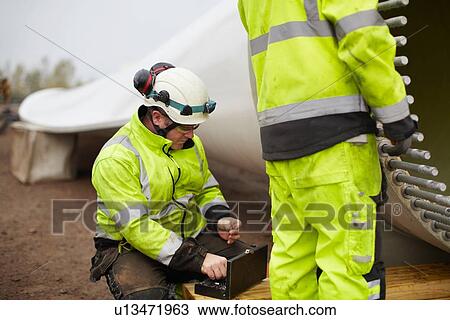 Stock Image - Engineers working on wind turbine. Fotosearch