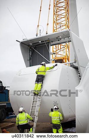 Stock Image - Engineers working on wind turbine. Fotosearch