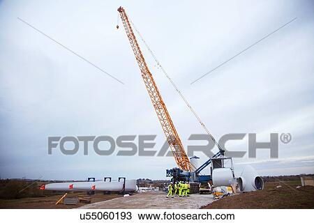 Stock Image - Engineers working on wind turbine. Fotosearch