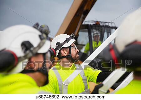 Stock Image - Engineers working on wind turbine. Fotosearch