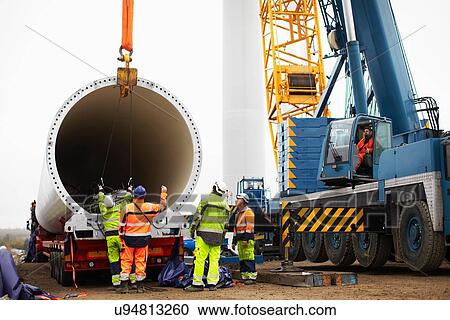 Stock Image - Engineers working on wind turbine. Fotosearch