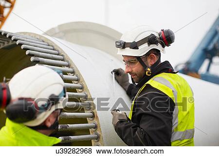 Engineers working on wind turbine View Large Photo Image Stock Photo - Engineers working on wind turbine. Fotosearch