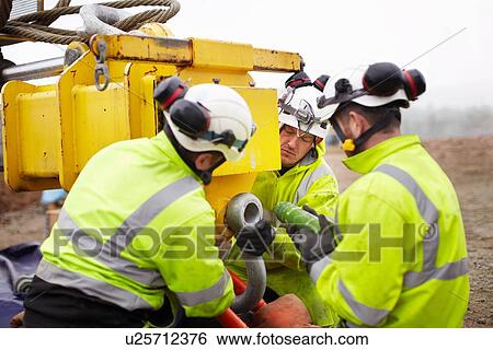 Stock Photograph - Engineers working on wind turbine. Fotosearch