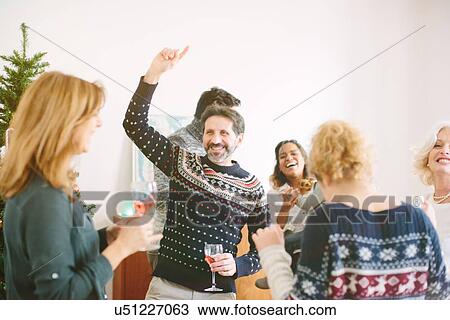 Stock Image - Family dancing at family Christmas party. Fotosearch