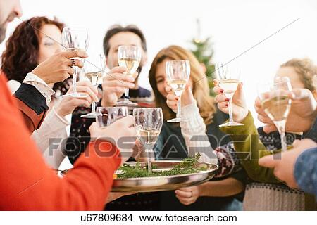 Picture - Family toasting at family Christmas party. Fotosearch