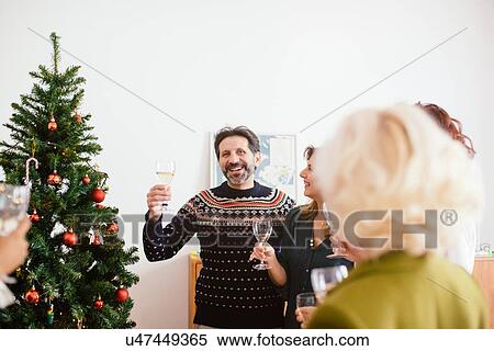 Family toasting at family Christmas party View Large Photo Image Stock Photography - Family toasting at family Christmas party. Fotosearch