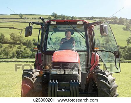 Farmer driving tractor in field View Large Photo Image Stock Image - Farmer driving tractor in field. Fotosearch