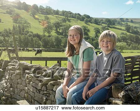 "Farmer's children sitting on dry stone wall, portrait" View Large Photo Image Stock Photo - "Farmer's children sitting on dry stone wall, portrait". Fotosearch