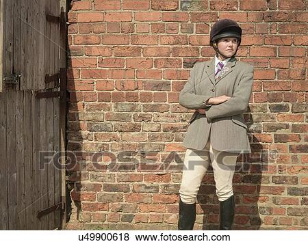 Stock Photo - "Farmer's daughter in riding clothes, looking away". Fotosearch