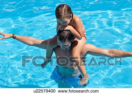 "Father and daughter in outdoor pool, daughter sitting on father's shoulders, elevated view" View Large Photo Image Stock Image - "Father and daughter in outdoor pool, daughter sitting on father's shoulders, elevated view". Fotosearch