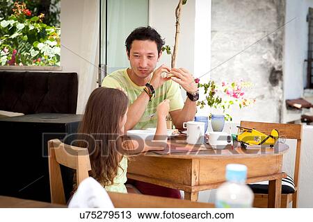 Father and daughter sitting at breakfast table together View Large Photo Image Stock Image - Father and daughter sitting at breakfast table together. Fotosearch