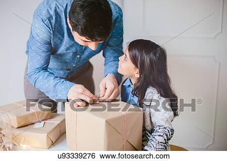 Father and daughter wrapping Christmas gifts View Large Photo Image Stock Photograph - Father and daughter wrapping Christmas gifts. Fotosearch