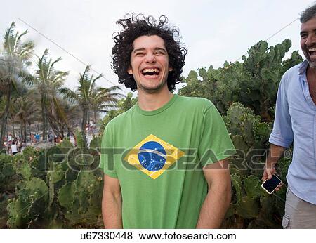 Stock Photo - "Father and son, palm trees in background". Fotosearch