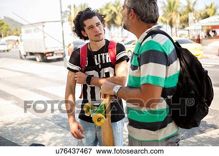 "Father and son skateboarders chatting on sidewalk, Copacabana, Rio De Janeiro, Brazil" View Large Photo Image Stock Photo - "Father and son skateboarders chatting on sidewalk, Copacabana, Rio De Janeiro, Brazil". Fotosearch