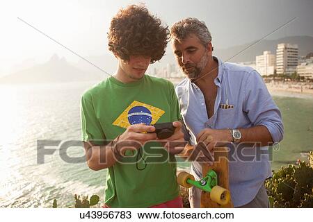 "Father and son with camera, Ipanema Beach, Rio de Janeiro, Brazil" View Large Photo Image Stock Image - "Father and son with camera, Ipanema Beach, Rio de Janeiro, Brazil". Fotosearch