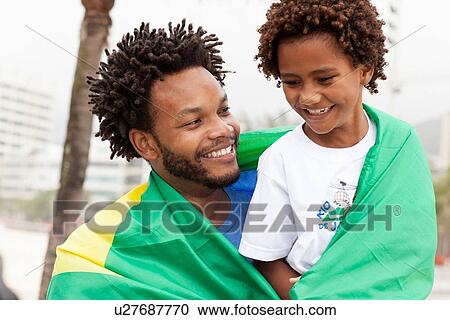 "Father and son wrapped in Brazilian flag on Ipanema beach, Rio De Janeiro, Brazil" View Large Photo Image Stock Image - "Father and son wrapped in Brazilian flag on Ipanema beach, Rio De Janeiro, Brazil". Fotosearch