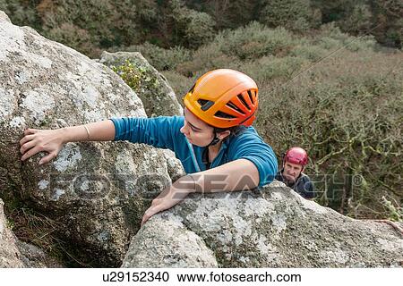Female rock climber gripping rocks View Large Photo Image Stock Image - Female rock climber gripping rocks. Fotosearch