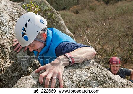 Female rock climber gripping rocks View Large Photo Image Stock Photo - Female rock climber gripping rocks. Fotosearch