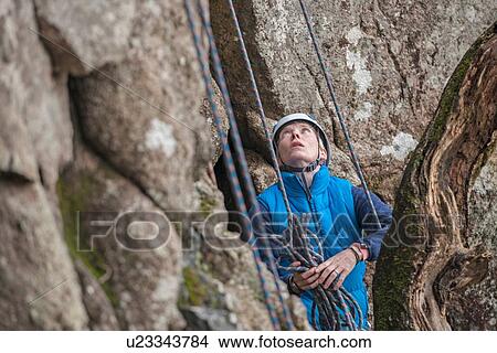 Female rock climber looking up View Large Photo Image Picture - Female rock climber looking up. Fotosearch