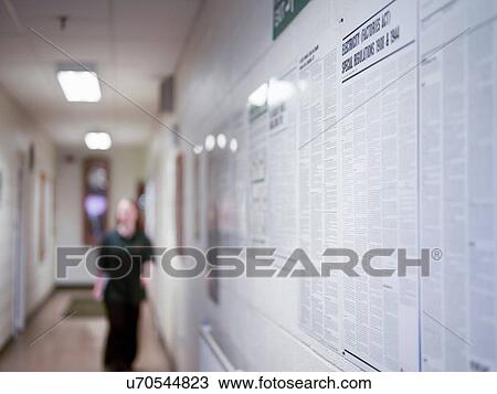Stock Image - Female worker in corridor of factory. Fotosearch