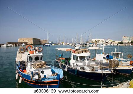 Stock Photo - "Fishing boats moored in harbor, Mykonos, Cyclades, Greece". Fotosearch