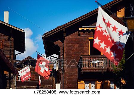 "Flags on chalet buildings, Valais, Switzerland" View Large Photo Image Stock Photo - "Flags on chalet buildings, Valais, Switzerland". Fotosearch